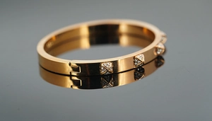 Macro shot of rose gold stainless steel hinged bracelet with sparkling pavé set crystals
