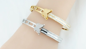 Detailed close-up of butterfly bangle with matte finish and pavé set sparkling crystals