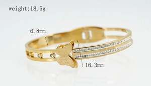 Detail showing gold butterfly bangle with crystal inlay and precise measurements
