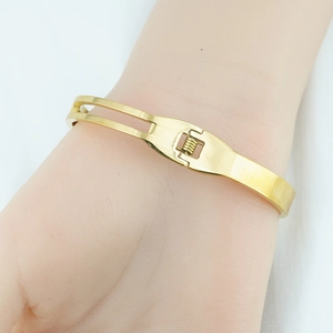 Polished gold stainless steel butterfly cuff bracelet for women featuring an asymmetric design