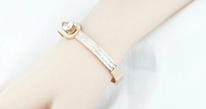 Close-up of rose gold bangle with large round zircon and micro-pave diamond setting