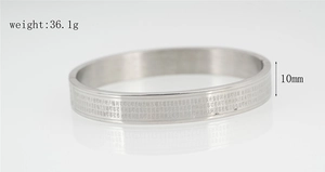 Detail of 10mm wide silver titanium steel mantra bangle weighing 36.1 grams