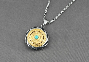Detailed macro view of retro stainless steel rotating zodiac pendant with blue turquoise stone