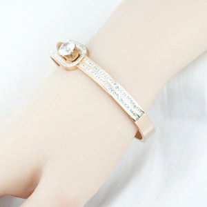 Luxe gold-plated titanium steel bracelet with a central round zircon and pavé setting