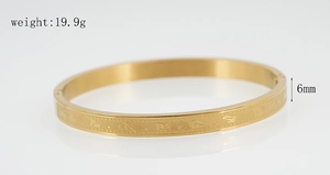 Detail shot of golden stainless steel bangle showing 6mm width and 19.9g weight specifications