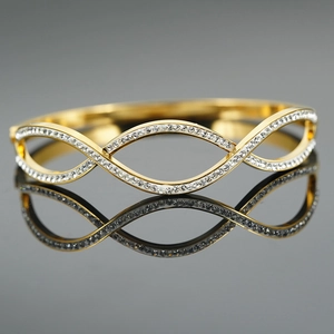 Gold plated stainless steel hollow wave bangle with sparkling pavé cubic zirconia