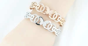 Close-up of butterfly bracelets with matte finish and sparkling rhinestones on the model's wrist