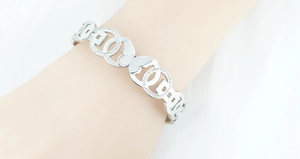 Detail of silver butterfly bracelet featuring frosted wings and sparkling zircons
