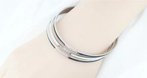 Detailed view of three-piece titanium steel bracelets with black enamel and zircon inlay