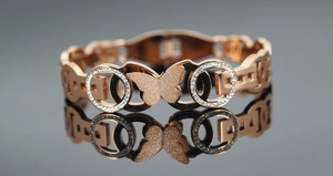 Detail of rose gold butterfly bracelet with frosted texture and micro-inlaid zircons