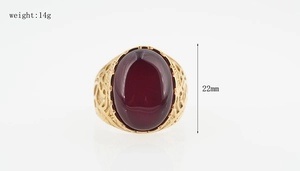 Detailed macro view of vintage gold ring with large red ruby and hollow carvings