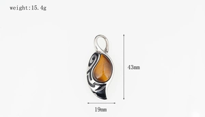 Tiger eye stone pendant in leaf shape with tribal scroll patterns and size dimensions