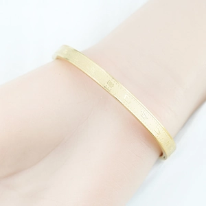 Golden titanium steel bangle with Buddhist scripture engraving and vacuum plating