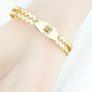 Polished gold zigzag bangle with double-row wave design and spring clasp for women