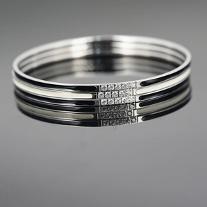 Three-piece stainless steel bangle set with black and white enamel and zircon accents