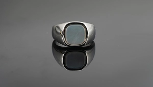 Detail of titanium steel signet ring with square dark grey mother of pearl inlay