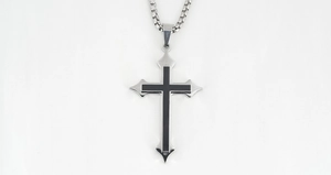 Macro shot of gothic stainless steel cross pendant with black enamel finish and box chain