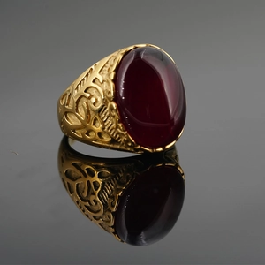 Vintage gold titanium steel ring featuring a large oval ruby and hollow filigree patterns