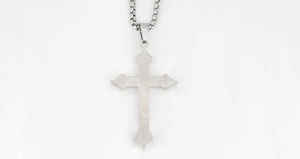 Close-up of gothic stainless steel cross pendant with detailed engraving and box chain