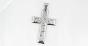 Detailed view of silver stainless steel cross pendant with Greek meander pattern engraving