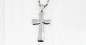 Detailed view of silver stainless steel triple layer cross pendant with polished box chain
