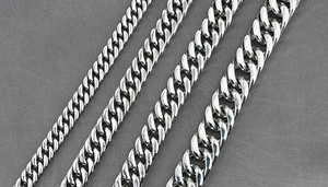 Detail showing four different widths of silver Cuban link chains in polished stainless steel