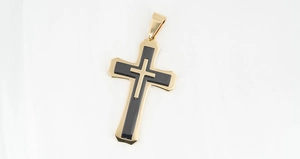 Detail shot of a three-layered titanium steel cross pendant in gold and black finish