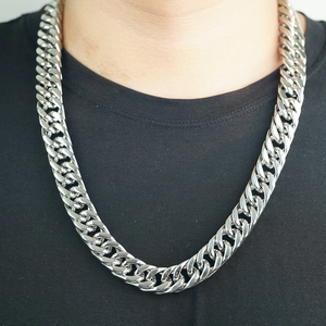 Men's stainless steel Cuban link chain necklace in silver finish worn on black t-shirt