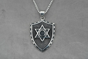 Macro shot of vintage shield pendant with hexagram detail on durable stainless steel chain