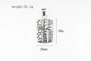 Macro view of vintage silver cross pendant with tire tread texture and stone patterns