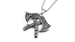 Detail of vintage Viking battle axe pendant with wolf relief and polished steel chain