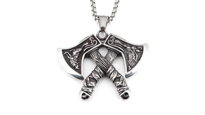 Close-up of vintage silver Viking double axe pendant with intricate dragon engravings