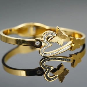 Gold butterfly heart bangle with sparkling rhinestones and a polished mirror finish