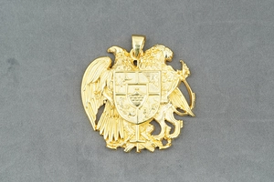 Detailed close-up of Armenian coat of arms eagle and lion shield pendant in gold finish