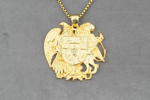 Macro detail of golden Armenia Coat of Arms eagle lion shield pendant with embossed texture