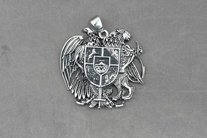 Detail showing vintage relief eagle and lion shield pendant in stainless steel