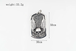 Close-up of hip hop skull dog tag pendant with wings design in polished silver finish