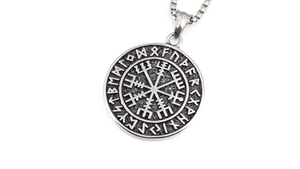 Macro detail of silver Viking Vegvisir compass pendant with Elder Futhark rune engravings