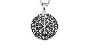 Detailed view of vintage silver Viking compass pendant with etched Nordic runes