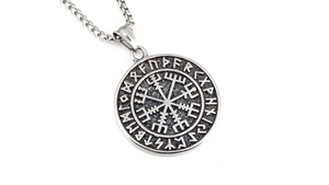 Macro view of Viking compass pendant with Elder Futhark runes and vintage box chain