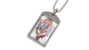 Macro shot of Ganesha pendant featuring colorful illustration on vintage steel plate