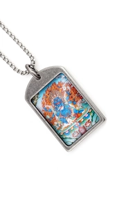 Macro shot of Tibetan style thangka pendant on a vintage titanium steel square link chain