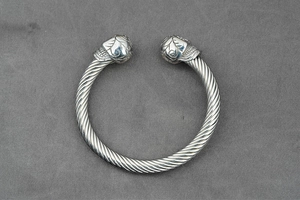 Detail view of silver punk cable cuff bracelet with engraved floral patterned ends