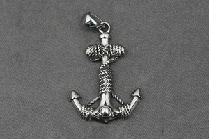 Detailed close-up of polished silver anchor pendant with realistic rope texture and bale
