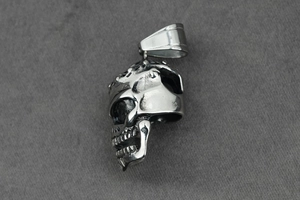 Detailed side view of punk skull pendant with polished bail and vintage bone textures