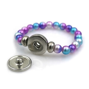 Purple iridescent beaded bracelet with metal snap button closure on white background