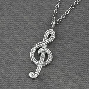 Sparkling treble clef pendant necklace in silver finish with micro-pave crystals