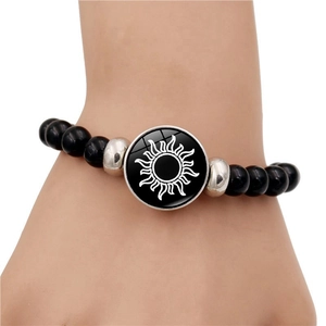 Luminous sun and moon beaded bracelet for couples featuring black beads and silver accents