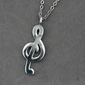 Polished silver G-clef musical note pendant necklace on a minimalist link chain