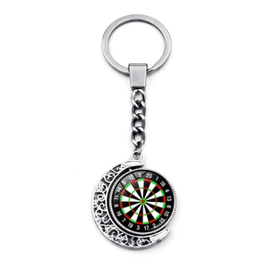 Detailed view of rotating dartboard pendant with silver crescent moon frame on keychain